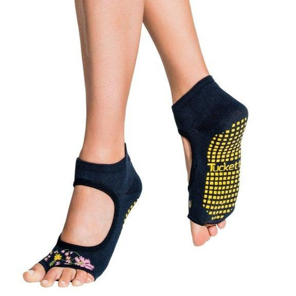 Navy blue allegro style grip socks with yellow grippers and flowers over the toes